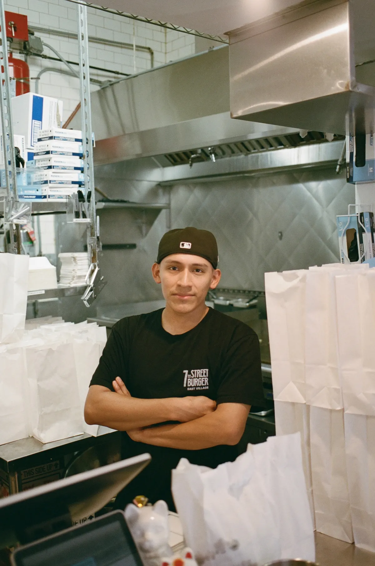 7th Street Burger team member standing inside the restaurant kitchen