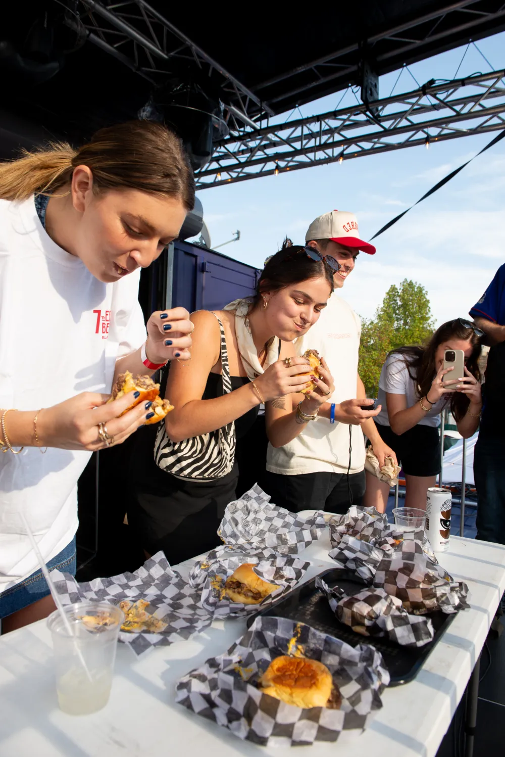 Guests enjoying 7th Street Burger cheeseburgers at a community event