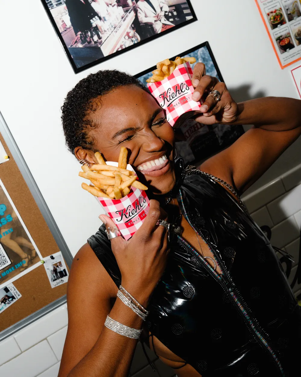 Guest enjoying 7th Street Burger fries during the Kiehl’s brand collaboration event