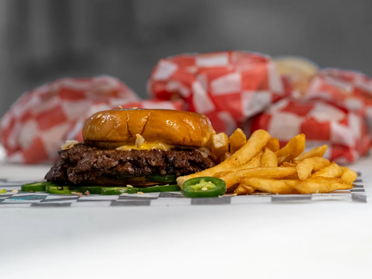 7th Street Burger cheeseburger served with fries and fresh jalapeños