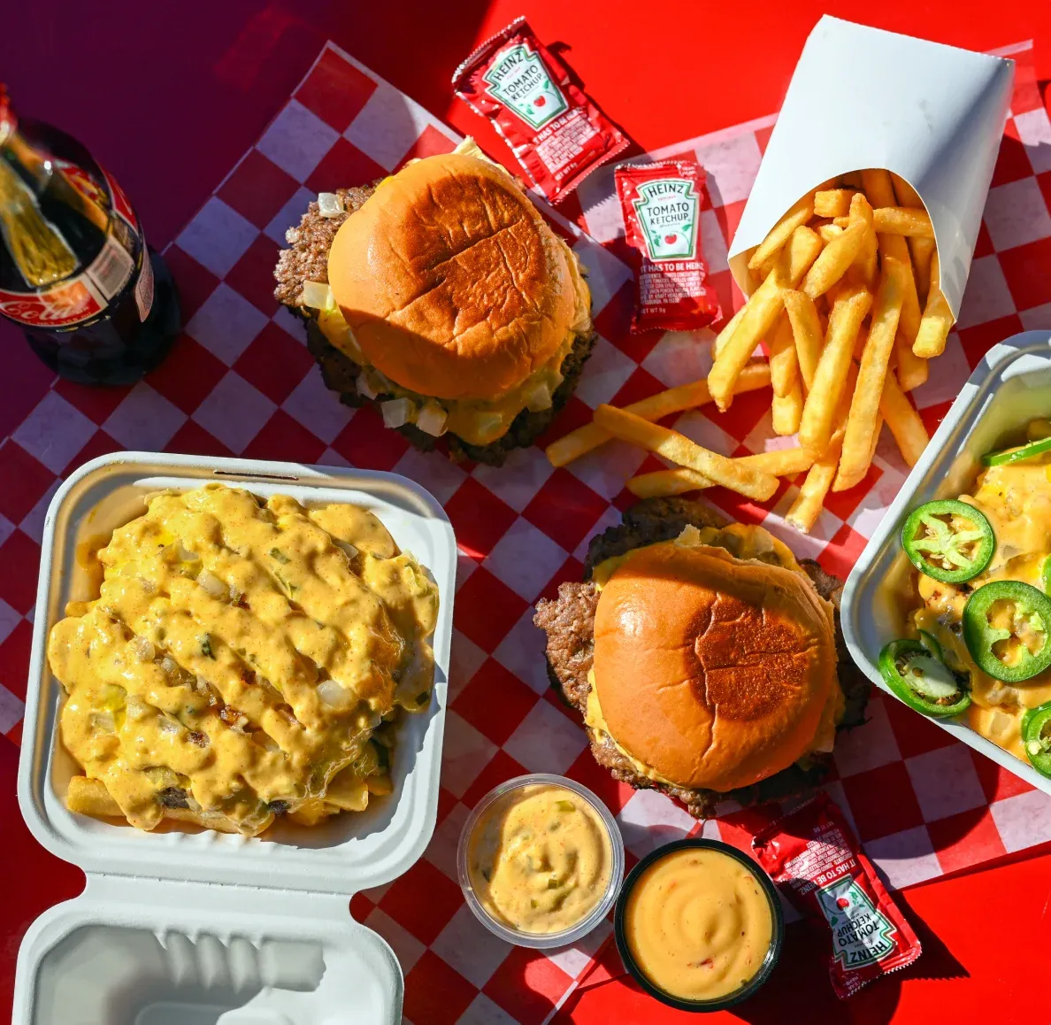 7th Street Burger cheeseburgers, loaded fries, and signature sauce served with hand-cut fries and Mexican Coca-Cola
