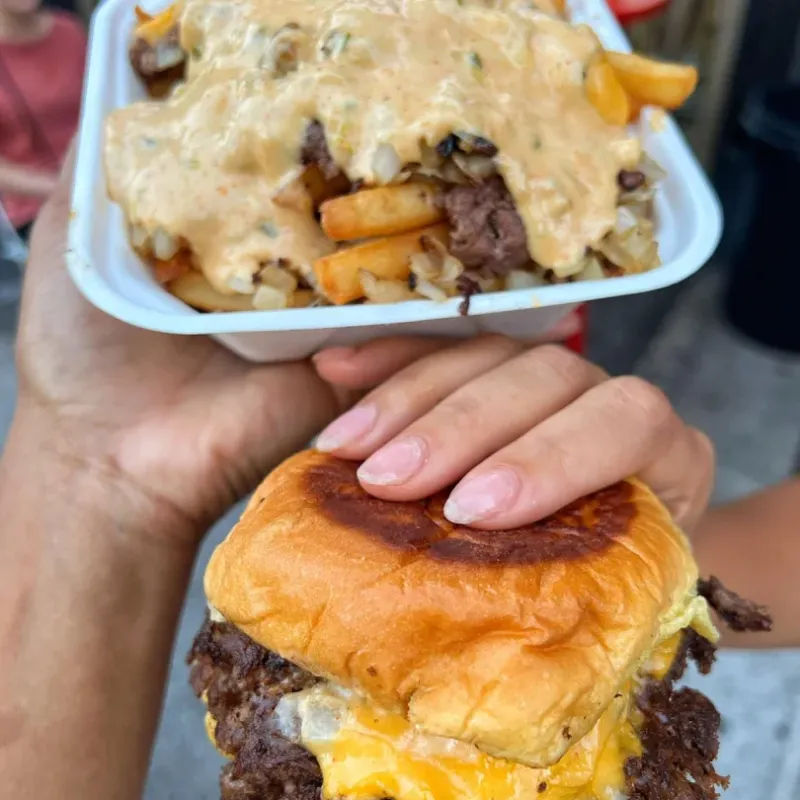 7th Street Burger cheeseburger served with loaded fries topped with house sauce and grilled onions