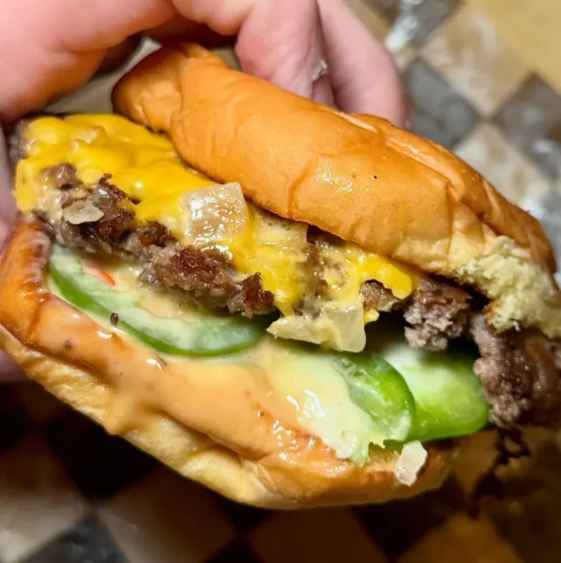 7th Street Burger cheeseburger with American cheese, pickles, grilled onions, and house sauce