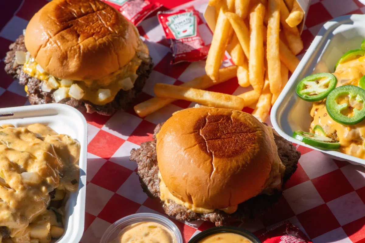 7th Street Burger cheeseburgers, loaded fries, fries, house sauce, and jalapeño-topped loaded fries