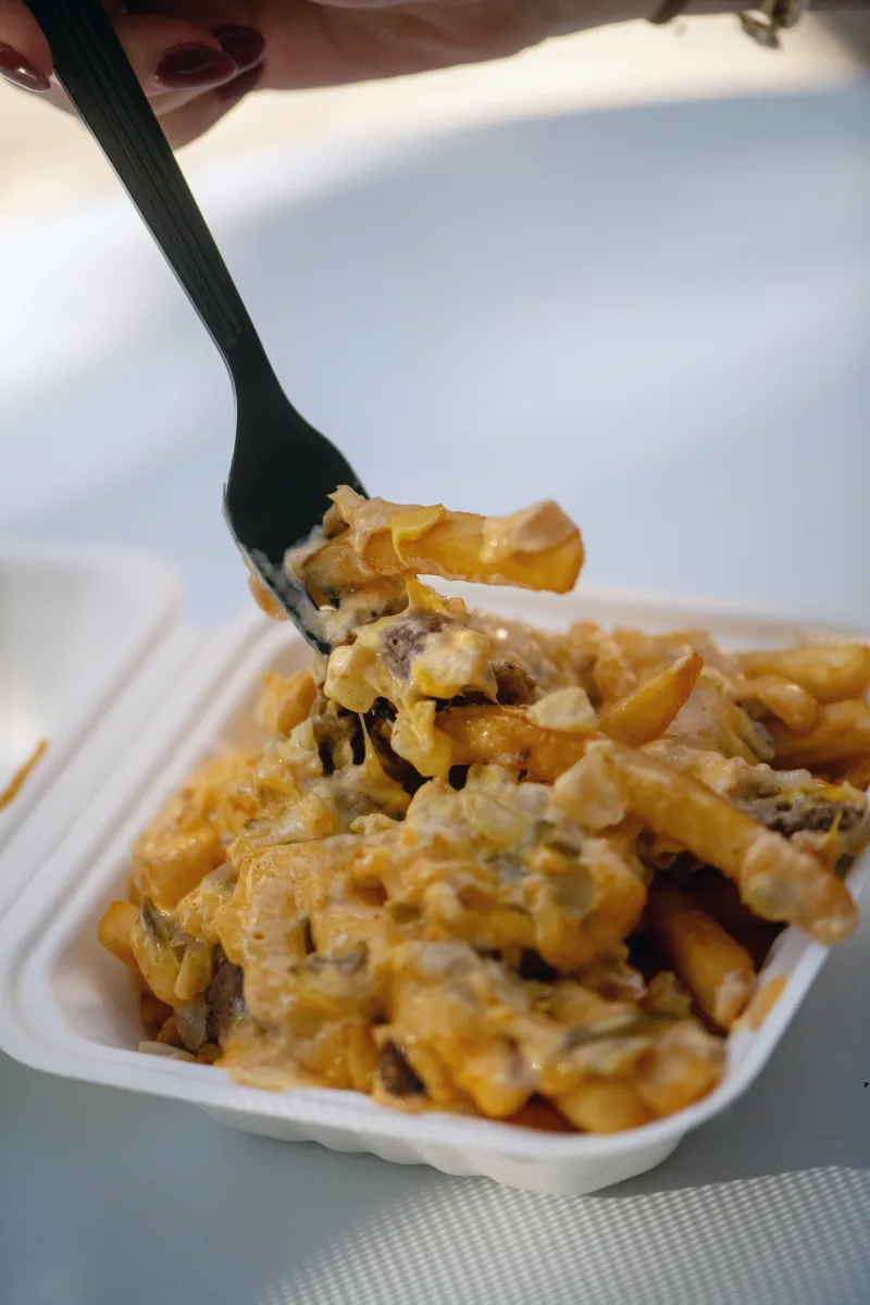 7th Street Burger loaded fries topped with house sauce, grilled onions, and chopped burger patties
